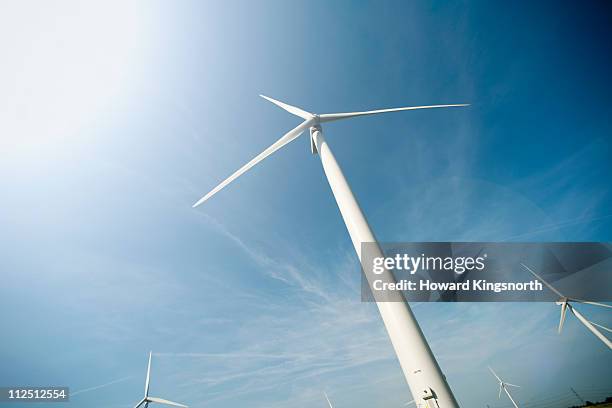 windturbines and bright blue sky - low angle view stockfoto's en -beelden