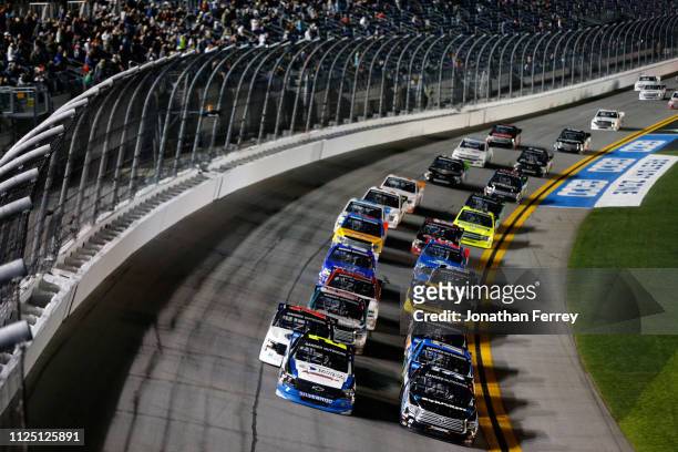Pack of trucks race during the NASCAR Gander Outdoors Truck Series NextEra Energy 250 at Daytona International Speedway on February 15, 2019 in...