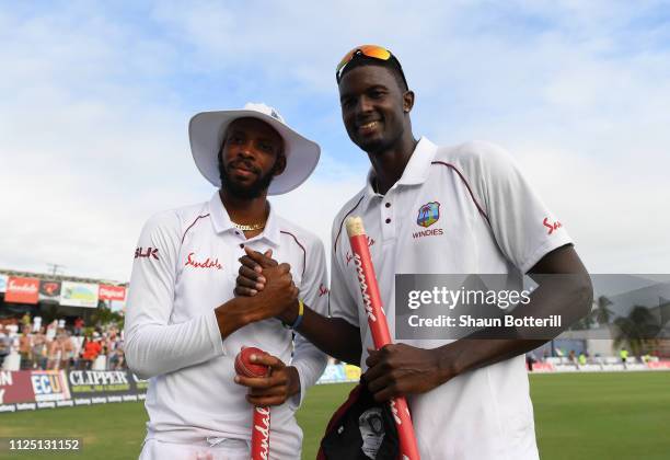 Jason Holder and Roston Chase celebrate after Day Four of the First Test match between England and West Indies at Kensington Oval on January 26, 2019...