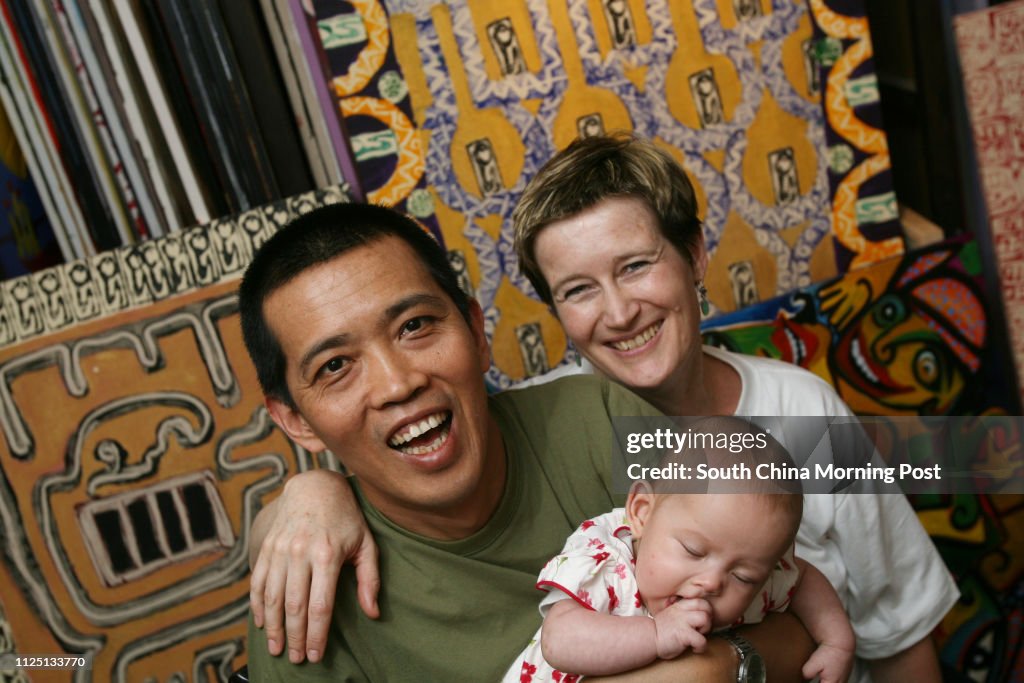 Portrait of Burmese artist Htein Lin with his wife Vicky Bowman and their baby Aurora. Karen Weber Gallery, Central. 21 MARCH 2008