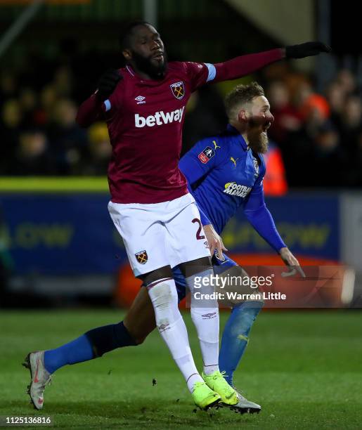 Scott Wagstaff of AFC Wimbledon celebrates past Arthur Masuaku of West Ham United after scoring his team's third goal during the FA Cup Fourth Round...
