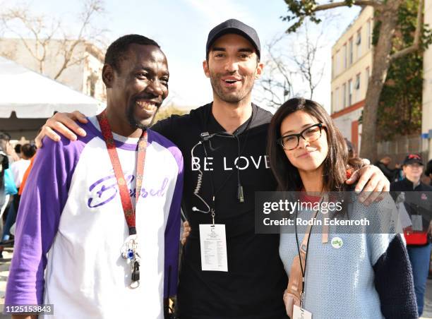 Guest Willie, Justin Baldoni, Gina Rodriguez pose for portrait at the Skid Row Carnival of Love on January 26, 2019 in Los Angeles, California.