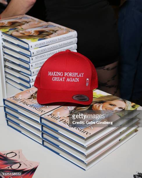 Making Foreplay Great Again" hat is displayed on a stack of books during a Stormy Daniels' signing for her book "Full Disclosure" at the 2019 AVN...