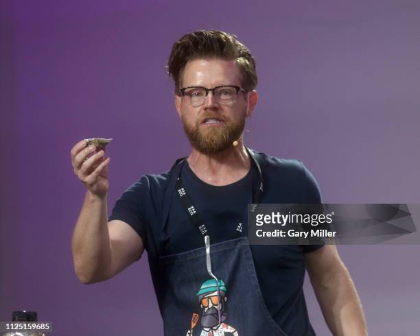 Chef Richard Blais gives a cooking demonstration during the sold out inaugural KAABOO Cayman Festival at Seven Mile Beach on February 15, 2019 in...