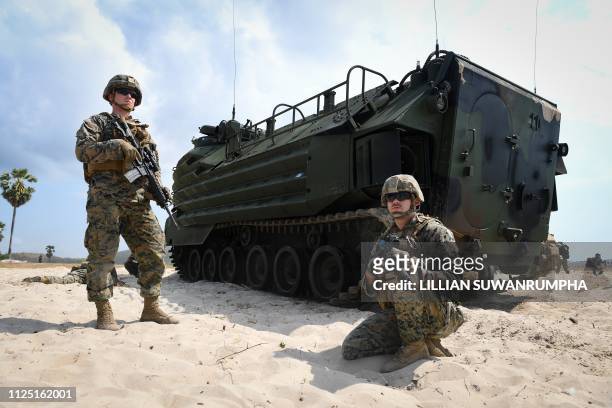 Marines guard an amphibious assault vehicle during an amphibious landing in Chonburi on February 16 at the multi-nation Cobra Gold military...