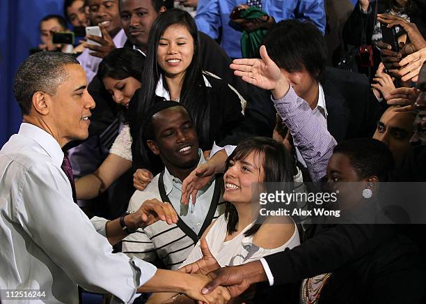 President Barack Obama shakes hands with audiences at the end of a town hall meeting at the North Virginia Community College April 19, 2011 in...
