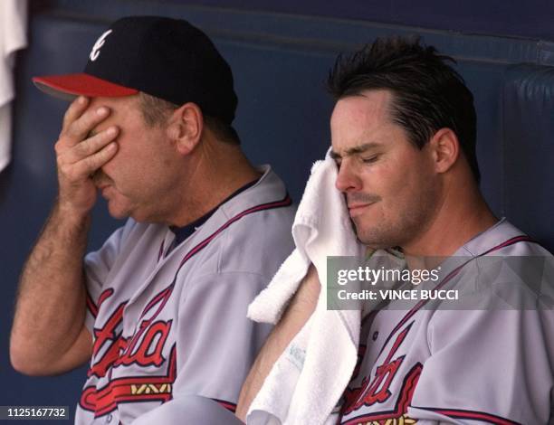 Atlanta Braves starting pitcher Greg Maddux sits on the bench with coach Leo Mazzone after giving up two runs in the fifth inning against the San...