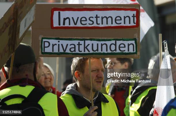 Supporters of the new left-wing "Stand Up" movement show a placard reading " Investment, Private customers" as they gather at a demonstration at...