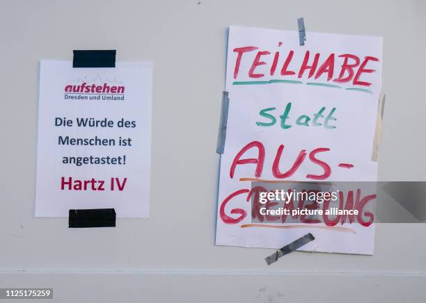 February 2019, Saxony, Dresden: Posters with the inscription "Die Würde des Menschen ist angetastet" Hartz IV and "Teilhabe statt Ausgrenzung" of the...