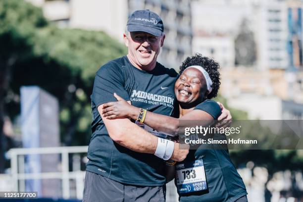 Laureus Chairman Sean Fitzpatrick hugs Laureus Academy Member Tegla Louroupe after finishing in the 1000m Sport for Good Run ahead of the 2019...