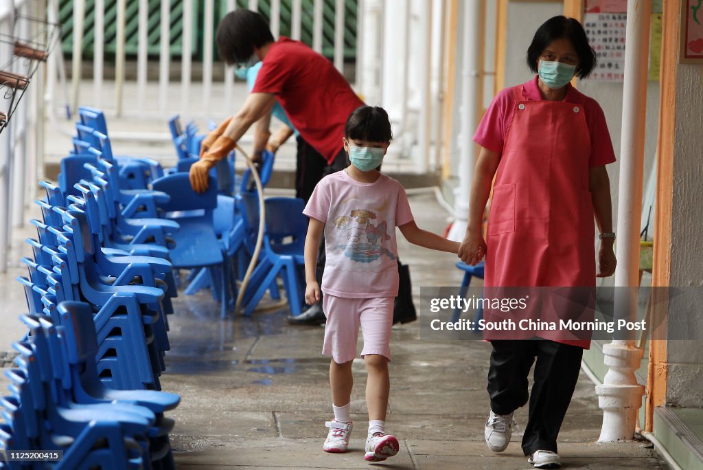 Cleaner cleaning chairs at Salvation Army Tin Ka Ping Kindergarten after outbreaks of scarlet fever . A child died of this month after catching the disease. 22JUN11
