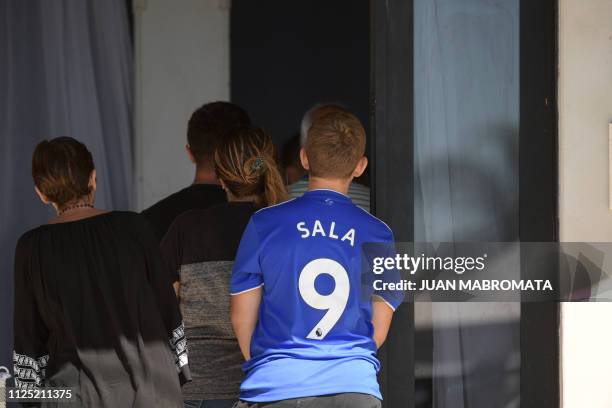 Boy wearing a jersey of Cardiff City FC with late Argentine football player Emiliano Sala's name and number, arrives at the Club Atletico y Social...