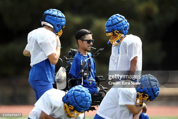 Coach Rob Mendez, the head coach for the Prospect High School Junior Varsity football team, talks to team during practice on August 7, 2018 in...