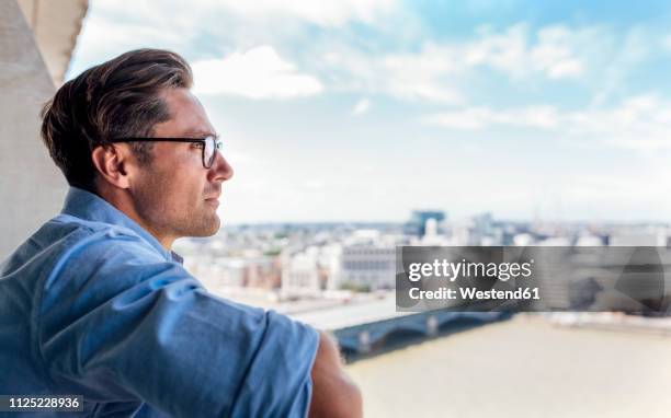 uk, london, man looking at the city on a roof terrace - man look sky stock pictures, royalty-free photos & images