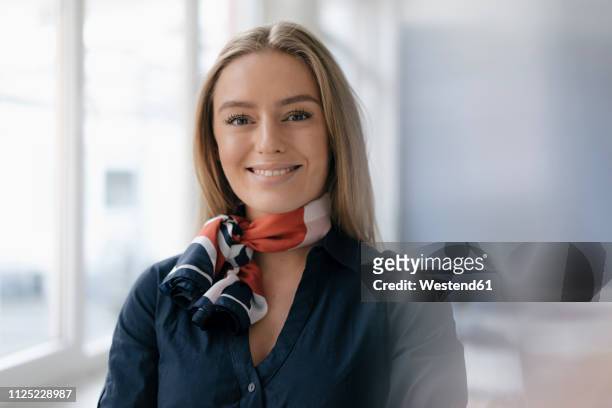 portrait of smiling young stewardess - flight attendants stock-fotos und bilder
