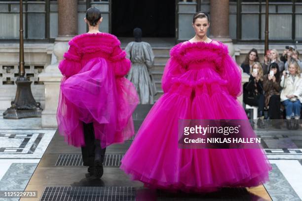Models present creations from designer Molly Goddard during her 2019 Autumn / Winter collection catwalk show at London Fashion Week at the Durbar...