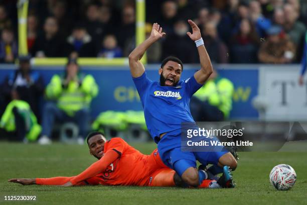 Andy Barcham of AFC Wimbledon is tackled by Mahlon Romeo of Millwall during the FA Cup Fifth Round match between AFC Wimbledon and Millwall at The...