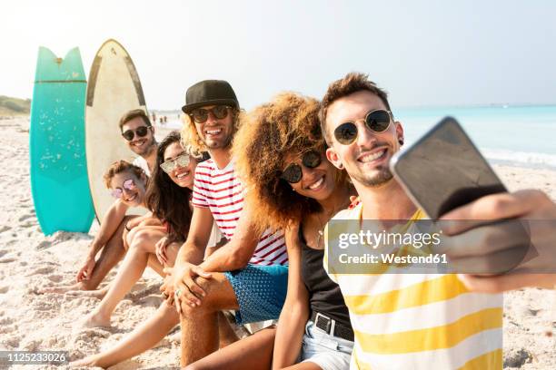 friends sitting on the beach, having fun, taking selfies - beach selfie bildbanksfoton och bilder
