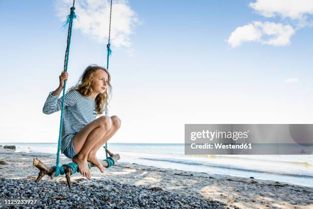 girl on a swing at the beach - rope swing stock pictures, royalty-free photos & images