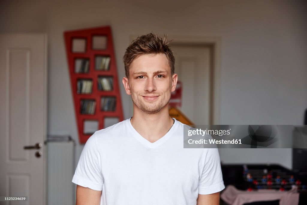 Portrait of smiling young man at home