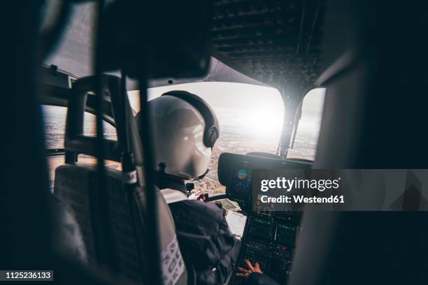 police pilot during the helicopter flight - inside helicopter stock pictures, royalty-free photos & images