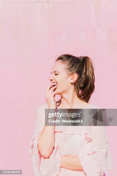 laughing young woman in front of pink wall - white blouse bildbanksfoton och bilder