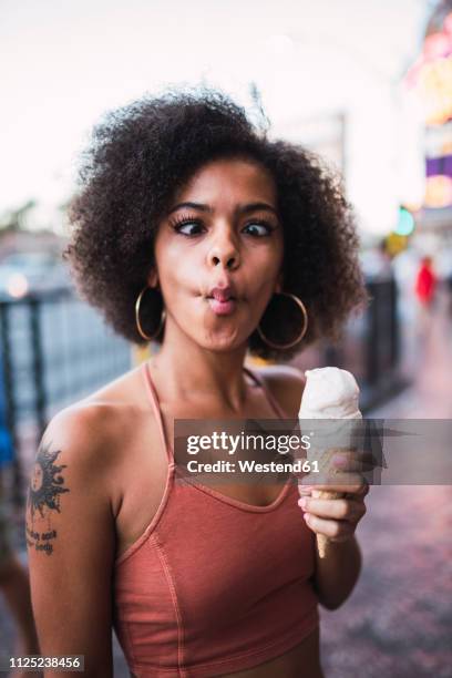 usa, nevada, las vegas, portrait of young woman holding ice cream cone grimacing - funny face woman stock pictures, royalty-free photos & images