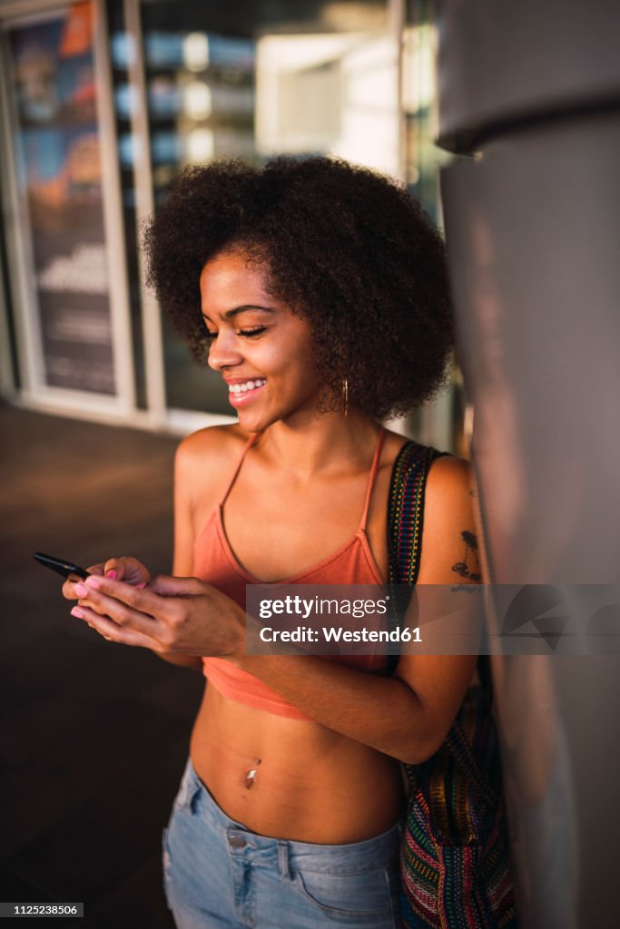 Happy young woman using cell phone