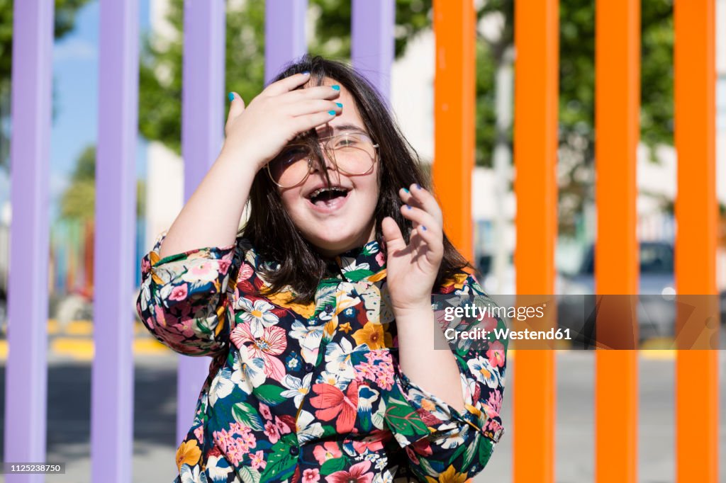 Teenager girl with down syndrome wearing glasses and smiling