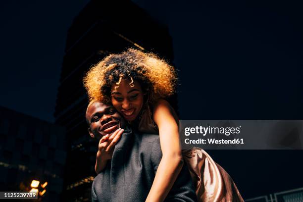 young couple having fun together at night outdoors - traje a rigor imagens e fotografias de stock