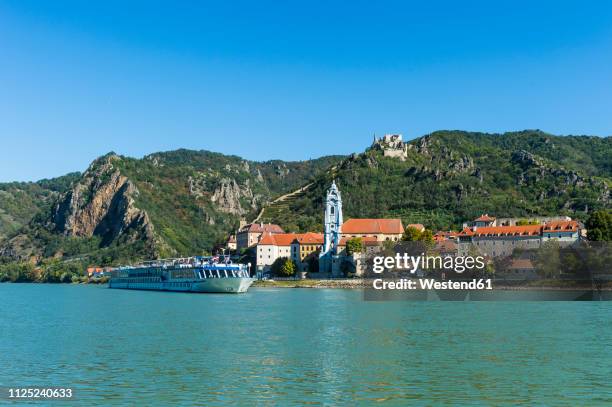 austria, wachau, cruise ship passing duernstein on the danube - cruise stockfoto's en -beelden