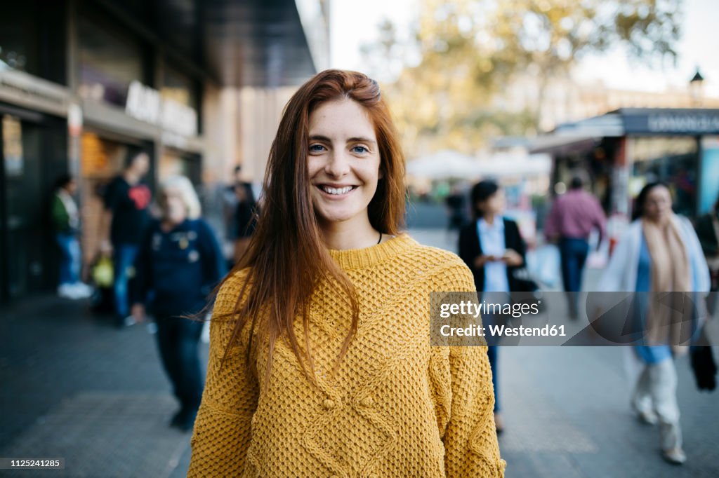 Portrait of a red-haired woman in the city