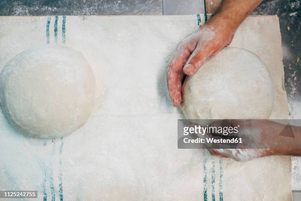 baker working with dough in bakery - knåda bildbanksfoton och bilder