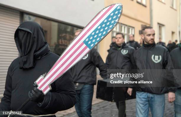 February 2019, Hessen, Fulda: During a march through the city centre, a wrapped-up demonstration participant of the right-wing extremist mini-party...