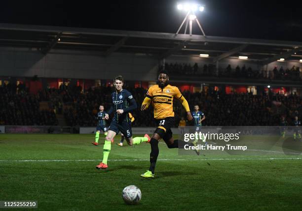 Jamille Matt of Newport County chases down the ball under pressure from John Stones of Manchester City during the FA Cup Fifth Round match between...