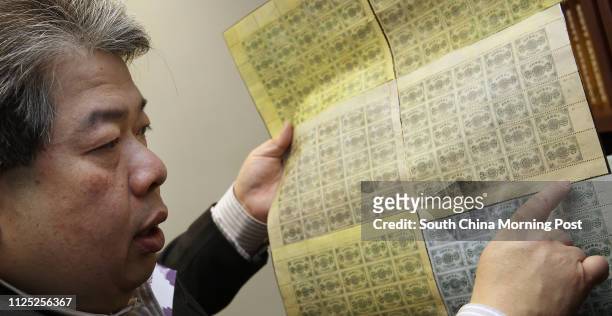 Dr. Sam Chiu, CEO of philatelic auction house David Feldman Limited, explains six sheets of Dowager stamps during the media preview of the its first...