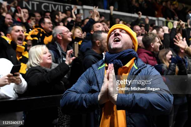 Newport County fans celebrate their team's first goal during the FA Cup Fifth Round match between Newport County AFC and Manchester City at Rodney...