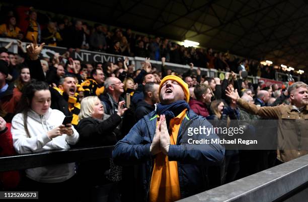 Newport County fans celebrate their team's first goal during the FA Cup Fifth Round match between Newport County AFC and Manchester City at Rodney...
