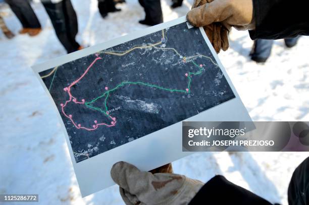 Musher inspects a map print out of the race routes during the second annual Blue Mountain Sled Dog and North Country Musher's mid distance Sled Dog...