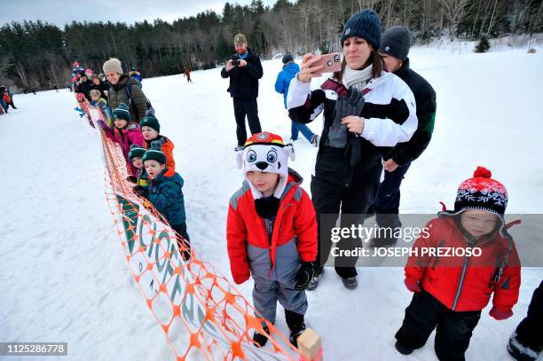 Members of the public line the start gate to watch the race during the second annual Blue Mountain Sled Dog and North Country Musher's mid distance...