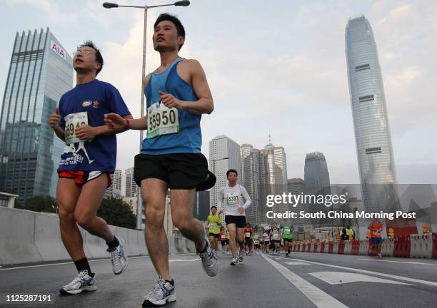 Runners compete in the Standard Chartered Marathon 2012 at Central Government Office in Admiralty. 05FEB12