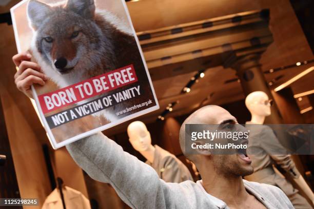 Animal rights activists protest the use of fur in the fashion industry outside a branch of designer clothing retailer Max Mara on Old Bond Street in...