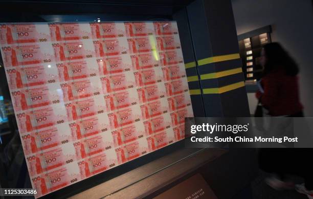 Person walk through HK$100 banknotes showcased in "Hong Kong Currency" exhibition at the Hong Kong Museum of History in Tsim Sha Tsui. The exhibition...