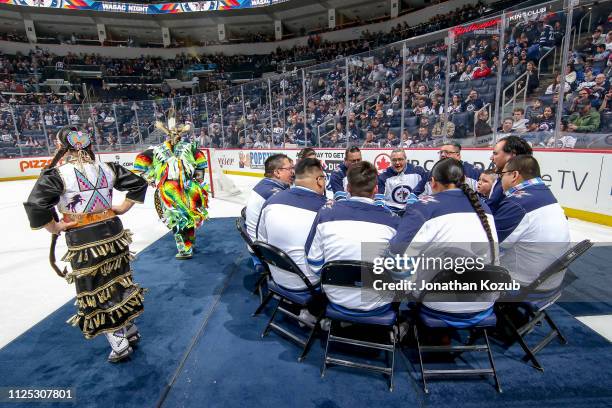 Indigenous dancers perform with a drum circle during the second intermission of WASAC Night between the Winnipeg Jets and the Ottawa Senators at the...