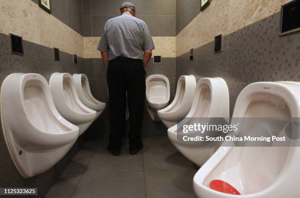An overcrowded urinal area in at a shopping mall of Celestial Height, a luxury up market private housing development near Ho Man Tin. The toilet with...