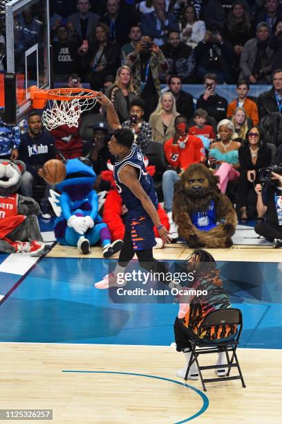 Dennis Smith Jr. #5 of the New York Knicks dunks the ball over Rapper, J Cole during the 2019 AT&T Slam Dunk Conest on February 16, 2019 at the...