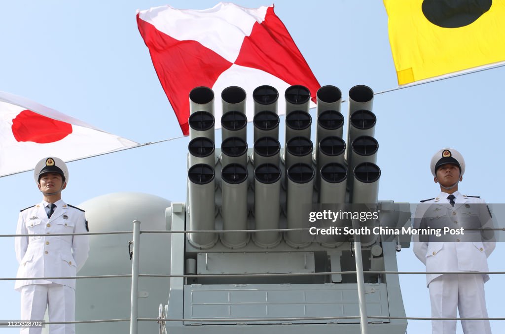 Chinese People's Liberation Army (PLA) Navy personnels stand under maritime signal flags on the deck of the Chinese naval guided missile destroyer Haikou (171) during a welcome ceremony as it docks at the Ngong Shuen Chau Naval Base in Hong Kong April 30,