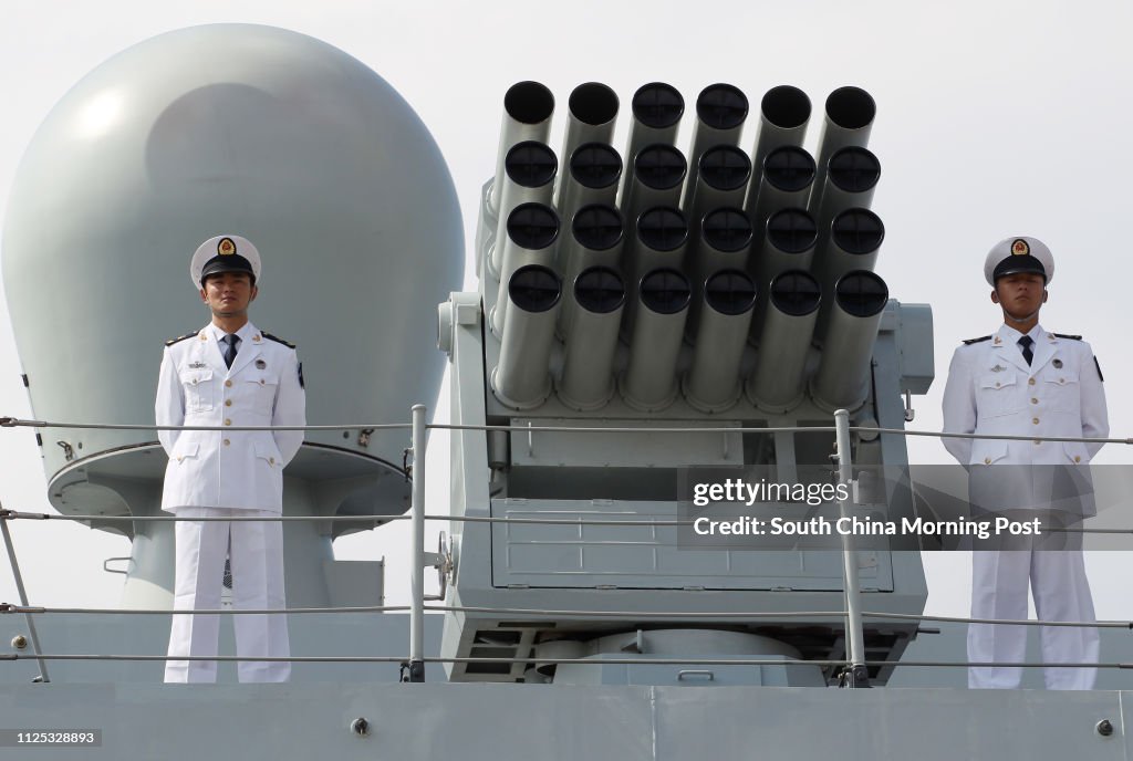 Chinese People's Liberation Army (PLA) Navy personnels stand next to the ship's euipments on the deck of the Chinese naval guided missile destroyer Haikou (171) during a welcome ceremony as it docks at the Ngong Shuen Chau Naval Base in Hong Kong April 30