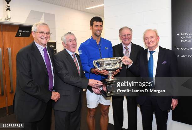 Novak Djokovic of Serbia meets previous players Roy Emerson, Ken Rosewall, Fred Sedgman and Rod Laver after his victory in the mens singles final...