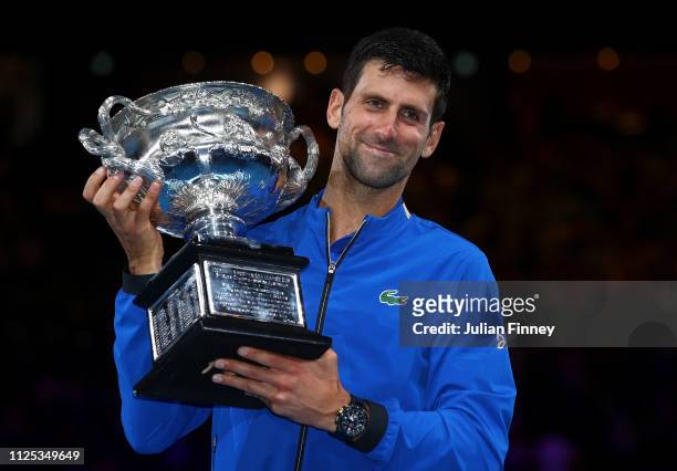 Novak Djokovic of Serbia poses with the Norman Brookes Challenge Cup following victory in his Men's Singles Final match against Rafael Nadal of Spain...